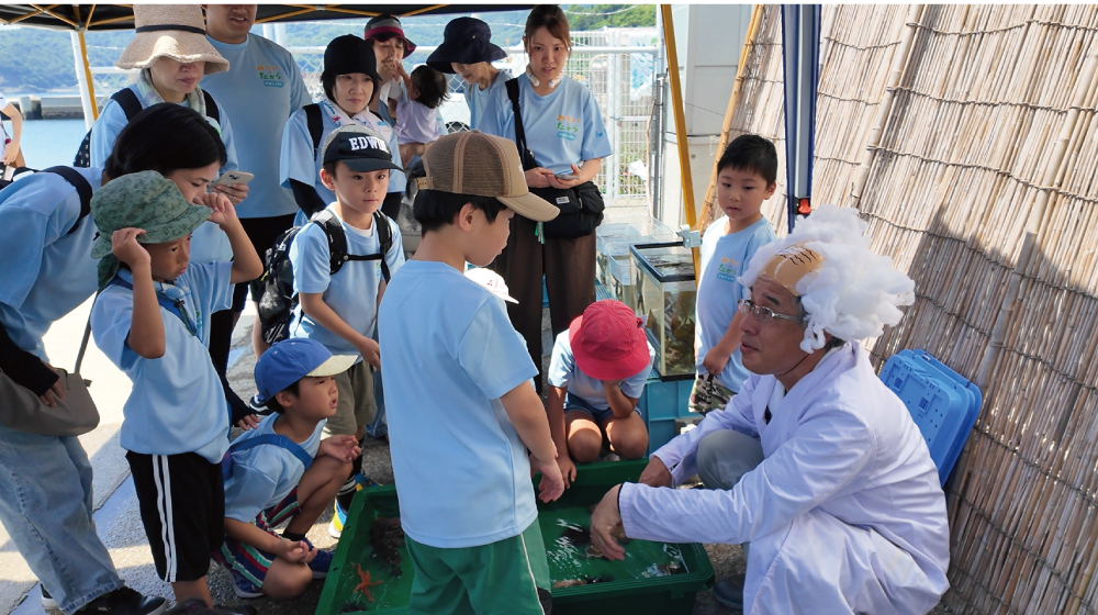 海の生きものについてはかせの説明を聞く子どもたち